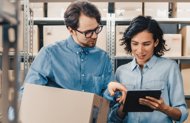 Team using tablet in warehouse